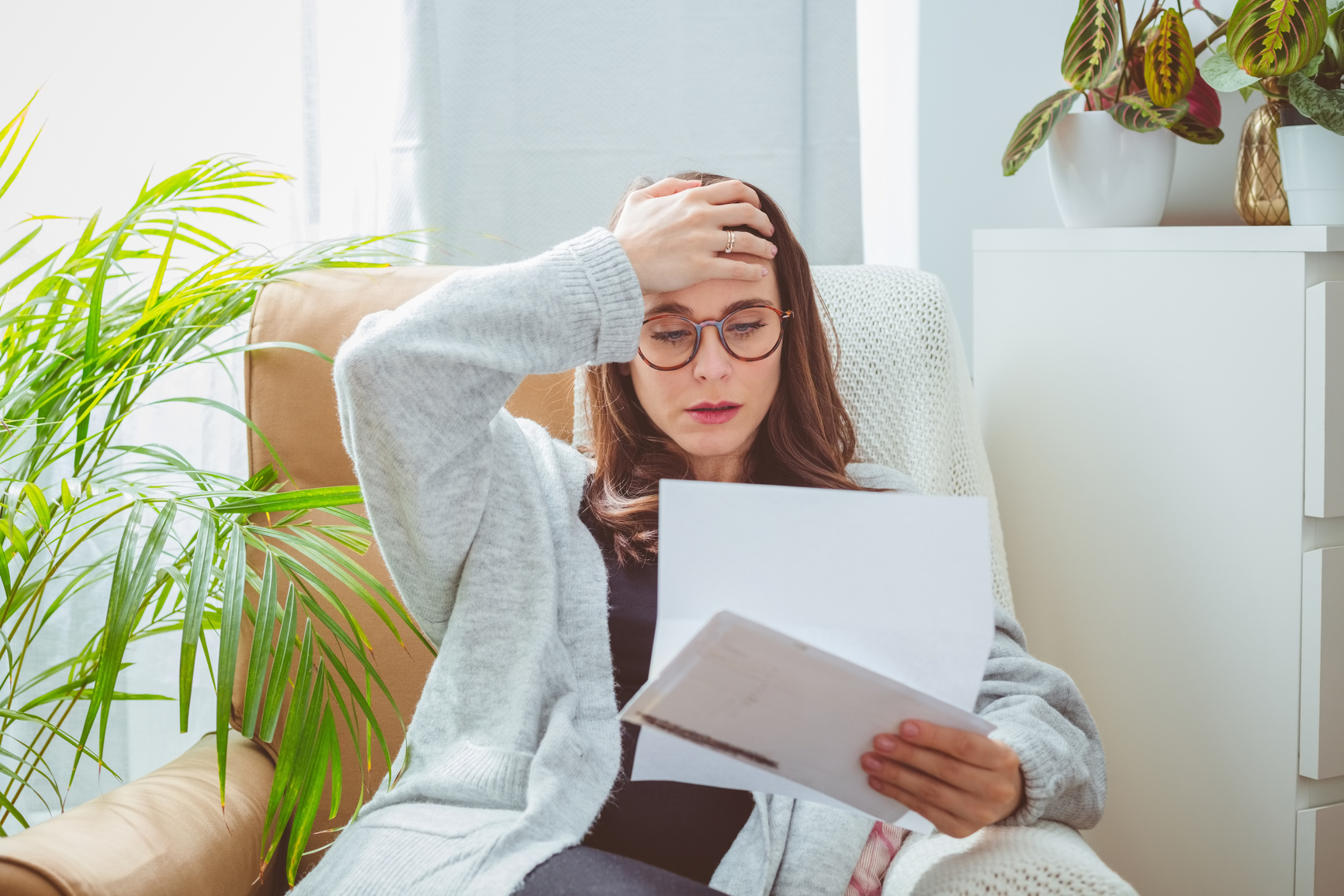 Worried woman reading bills